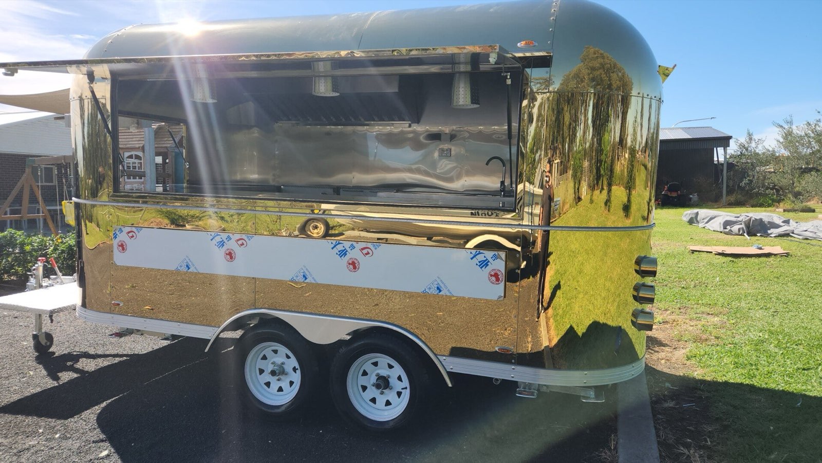 Full side view of the gold trailer and serving counter